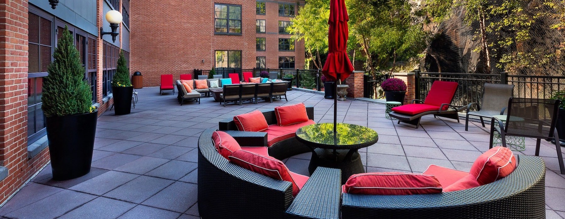 an outdoor lounge area with couches and chairs