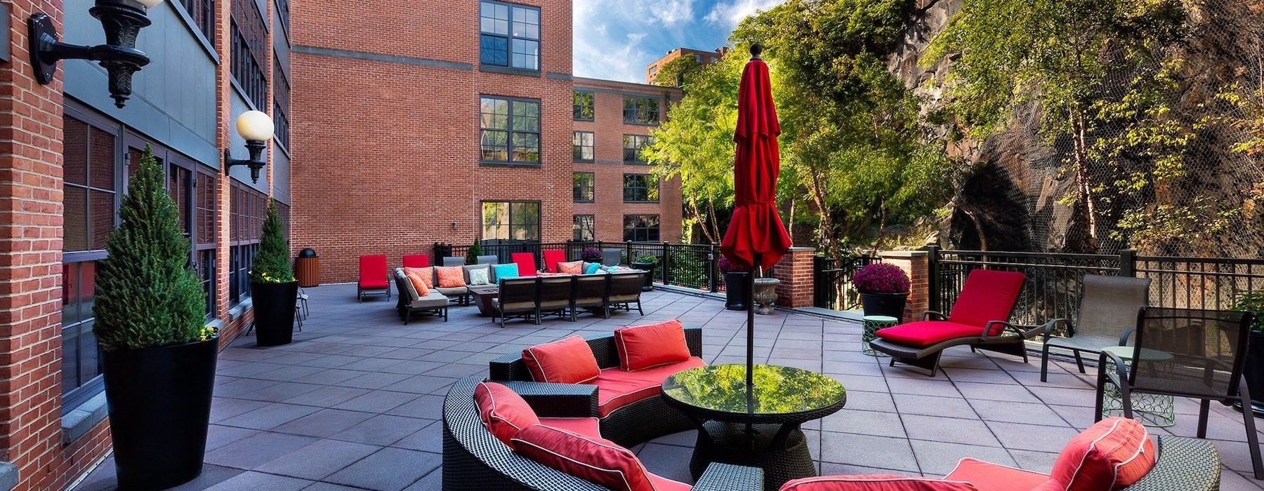 an outdoor lounge area with couches and chairs