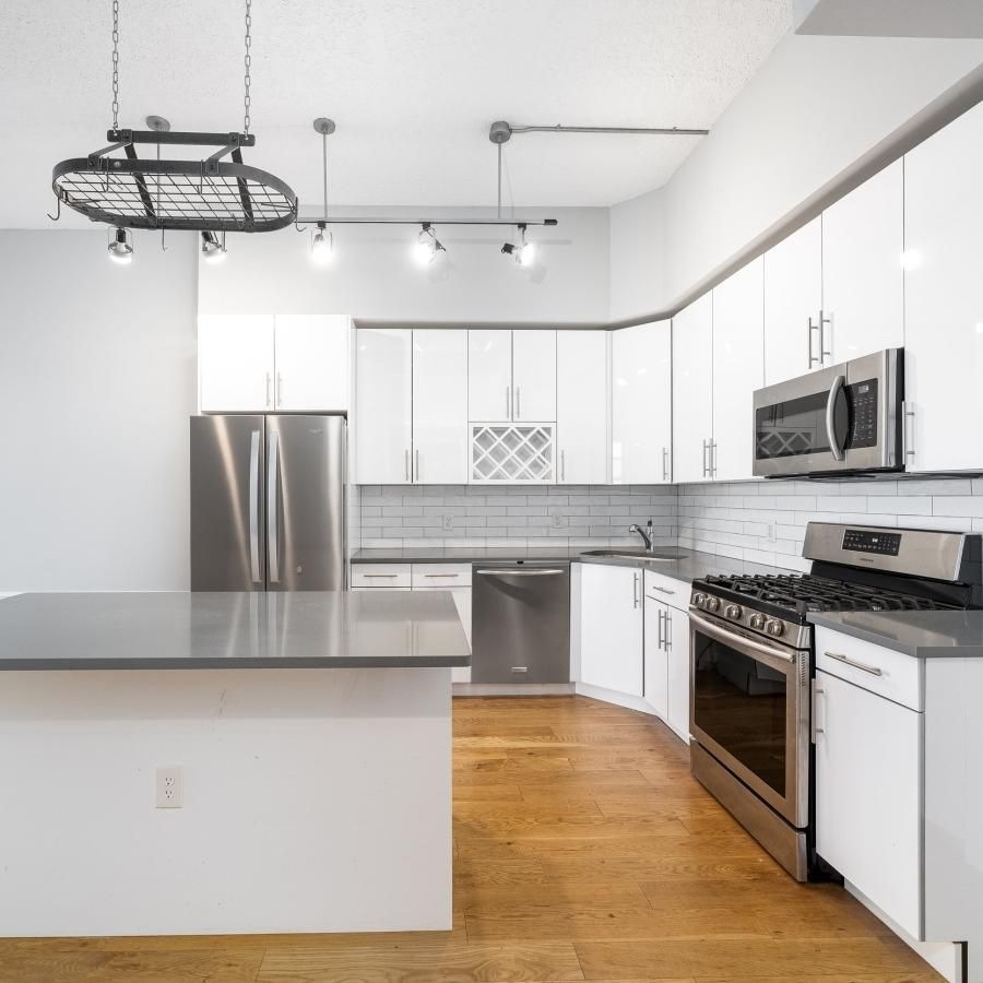 a kitchen with white cabinets