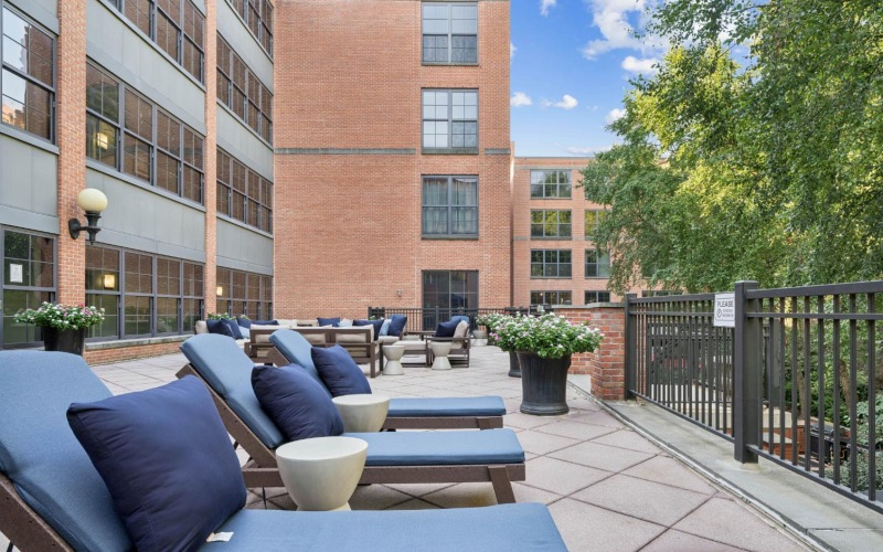 Outdoor courtyard at The Cliff Lofts pet friendly apartments in Jersey City with large couches and lounge chairs.	
