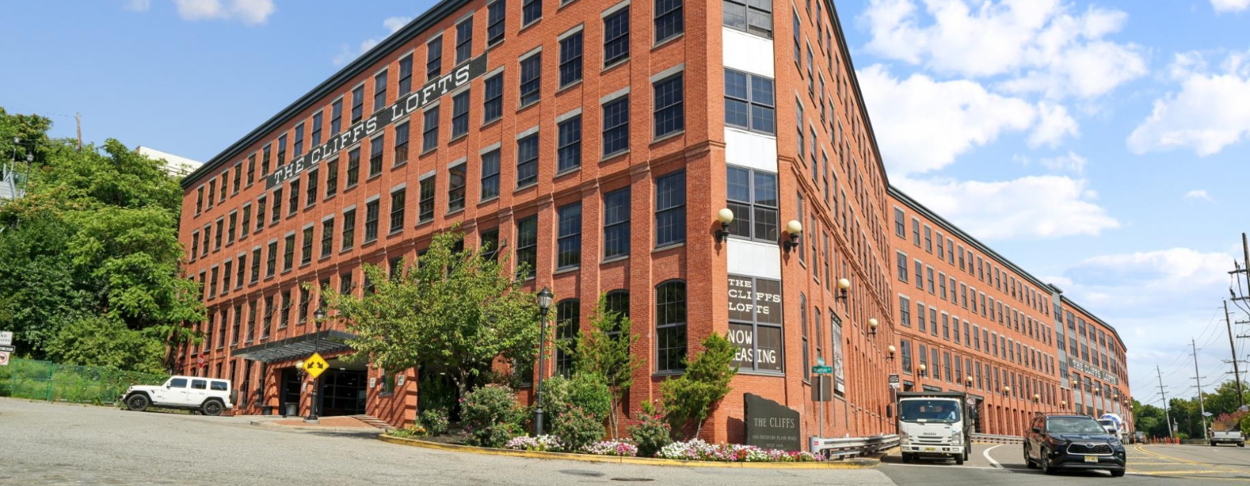 Outdoor of The Cliffs Lofts building showing a red brick building 