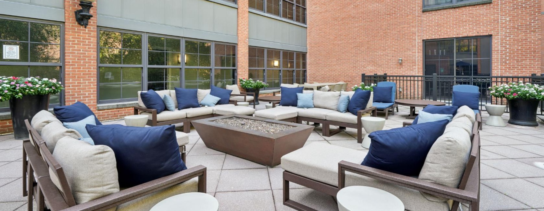 Outdoor lounge area with couch seating and lounge chairs at the best apartments in Jersey City at The Cliffs Lofts.